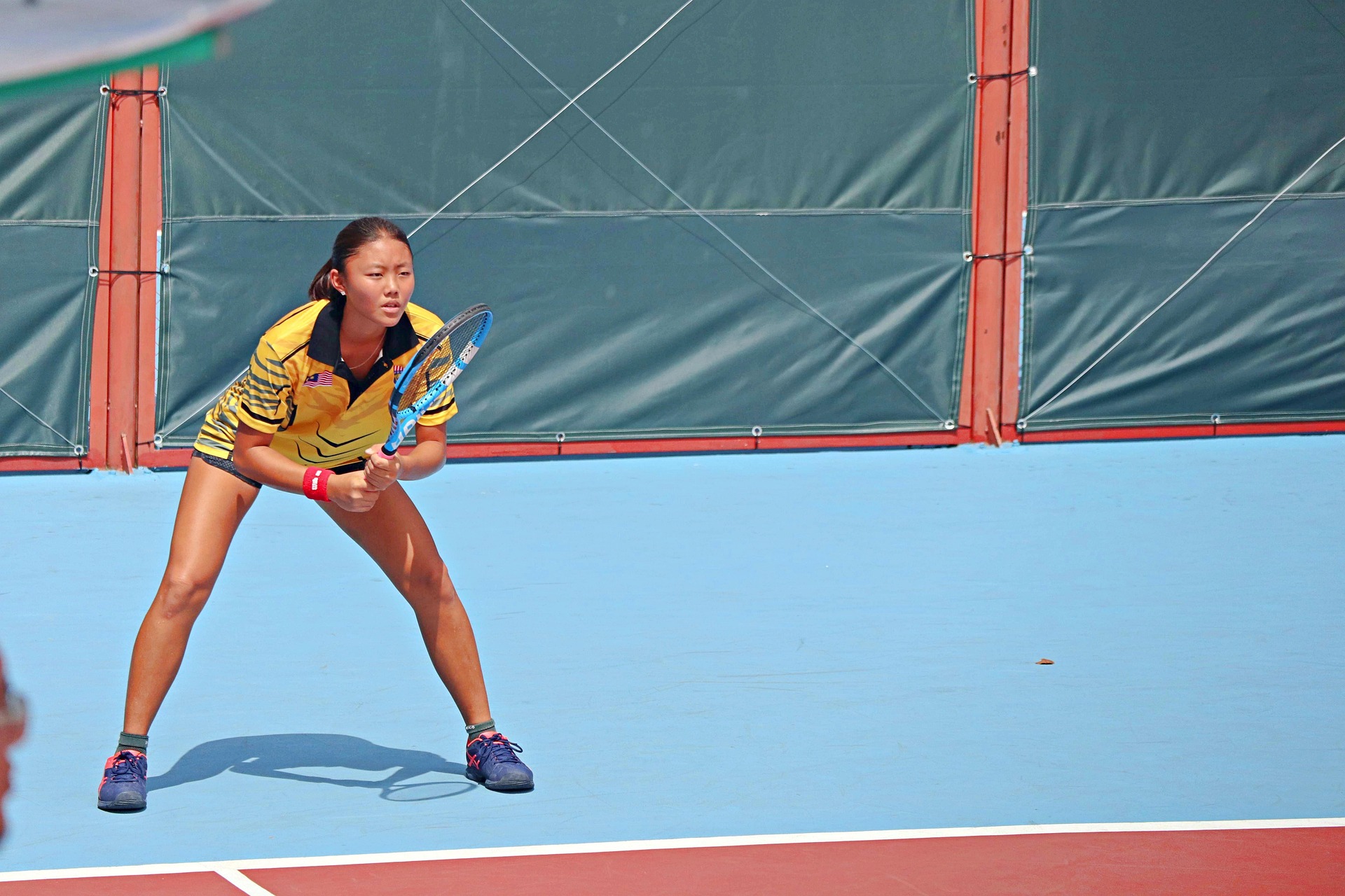 A woman playing lawn tennis.