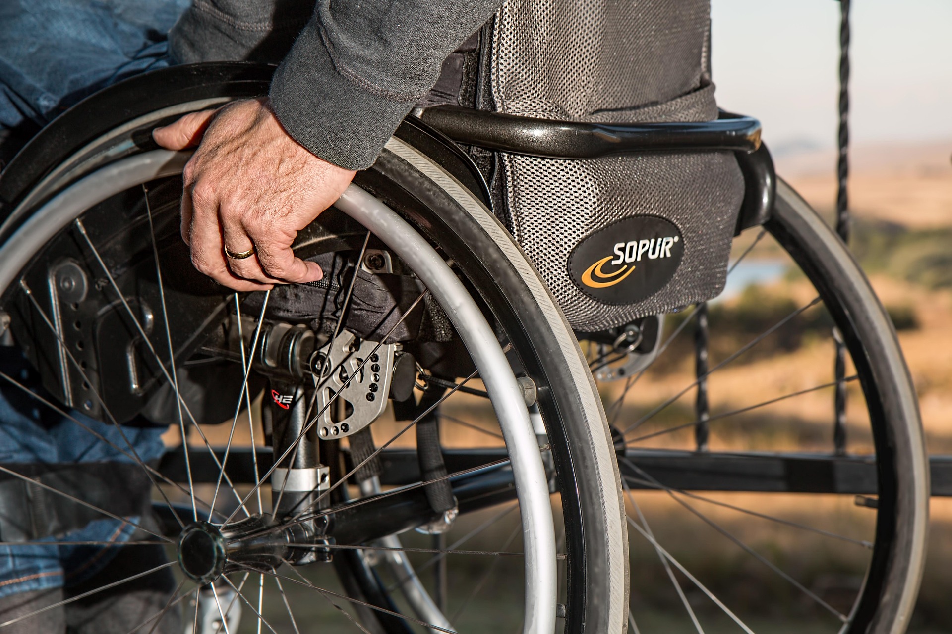 A zoomed in photo of a someone in wheelchair.