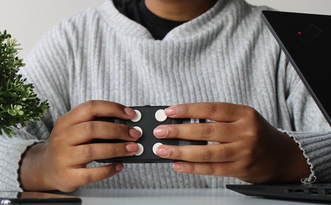 A woman holding a Hable One device.